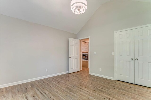 14 Brook Valley Ct SW, Rome, GA 30165 - unfurnished bedroom featuring high vaulted ceiling, light wood-style floors, baseboards, a chandelier, and a closet