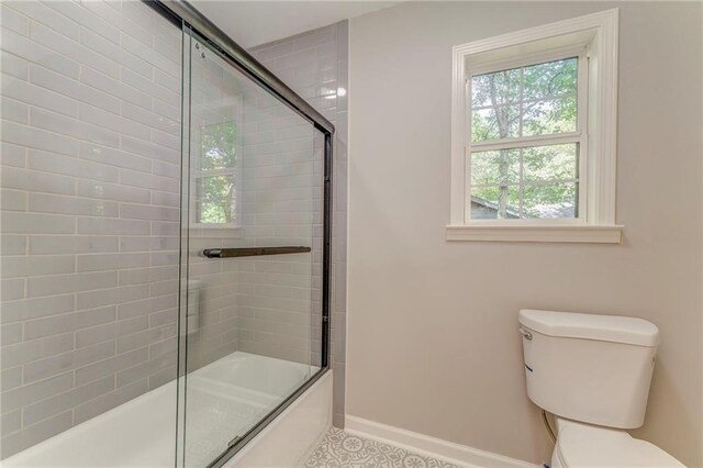 14 Brook Valley Ct SW, Rome, GA 30165 - bathroom with toilet, shower / bath combination with glass door, and baseboards