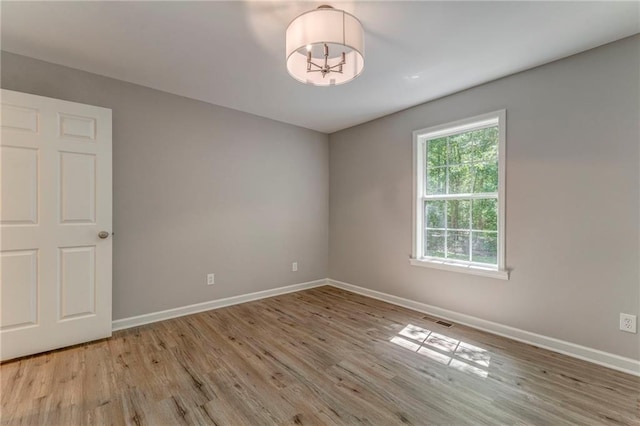 14 Brook Valley Ct SW, Rome, GA 30165 - empty room featuring wood finished floors, baseboards, and a chandelier