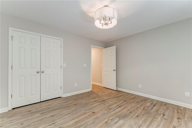 14 Brook Valley Ct SW, Rome, GA 30165 - unfurnished bedroom featuring a chandelier, light wood-type flooring, and baseboards