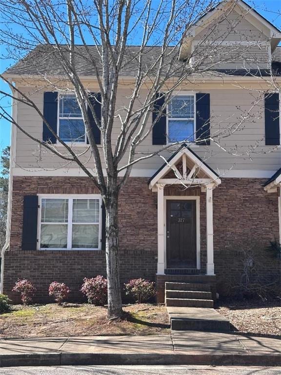 view of front facade with entry steps and brick siding