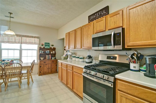 809 Longbranch Ln, Douglasville, GA 30134 - kitchen with stainless steel appliances, light countertops, light flooring, pendant lighting, and a textured ceiling