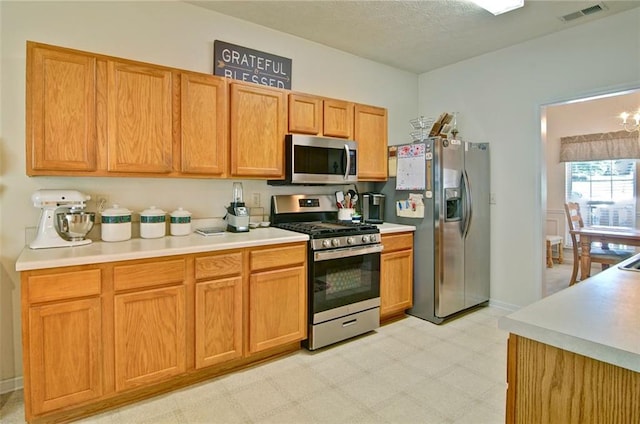 809 Longbranch Ln, Douglasville, GA 30134 - kitchen with appliances with stainless steel finishes, light flooring, light countertops, a textured ceiling, and baseboards