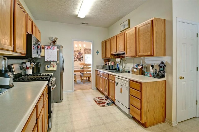809 Longbranch Ln, Douglasville, GA 30134 - kitchen featuring stainless steel appliances, a sink, light floors, light countertops, and a textured ceiling