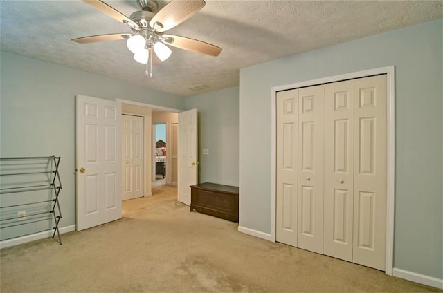 809 Longbranch Ln, Douglasville, GA 30134 - unfurnished bedroom featuring carpet, a textured ceiling, baseboards, a closet, and a ceiling fan