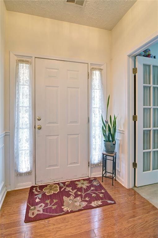 809 Longbranch Ln, Douglasville, GA 30134 - foyer entrance with wood finished floors, a textured ceiling, and plenty of natural light