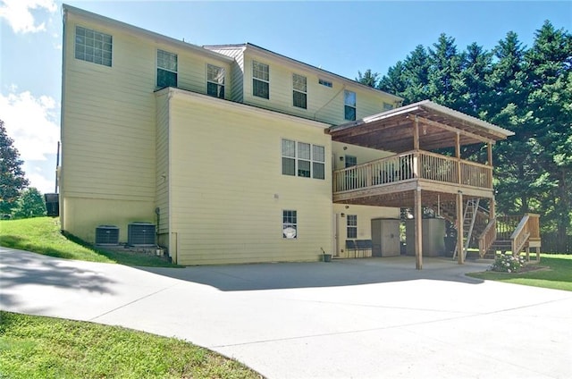 809 Longbranch Ln, Douglasville, GA 30134 - back of property with driveway, a wooden deck, stairs, and central air condition unit