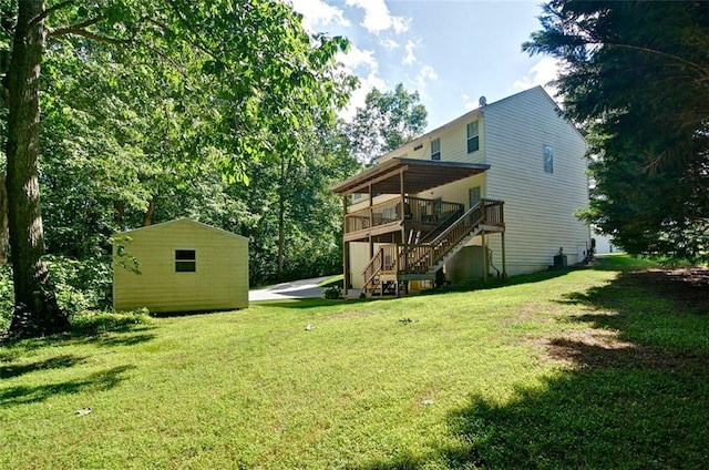 809 Longbranch Ln, Douglasville, GA 30134 - rear view of property featuring stairway, a wooden deck, a yard, and an outdoor structure