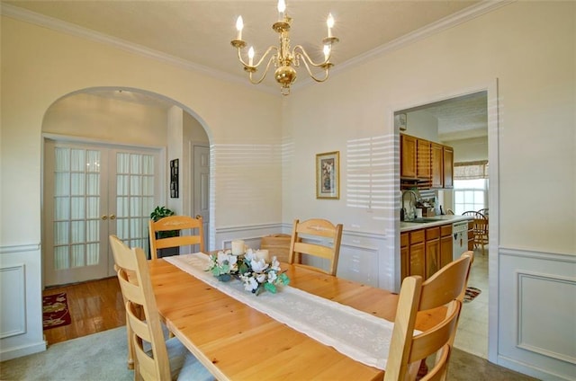 809 Longbranch Ln, Douglasville, GA 30134 - dining room with arched walkways, ornamental molding, a chandelier, and french doors
