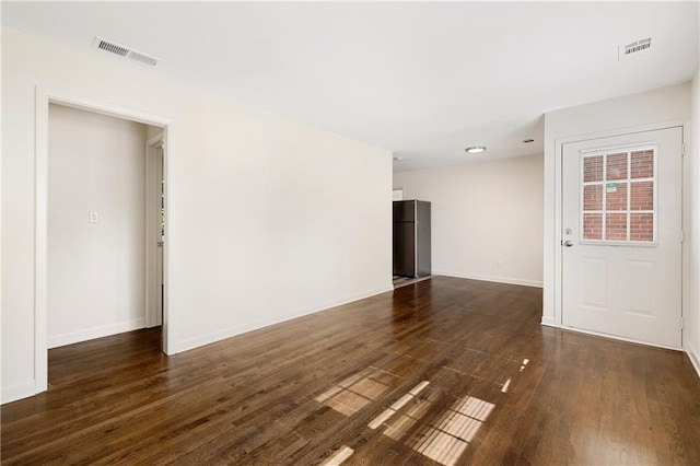 unfurnished room with dark hardwood / wood-style floors