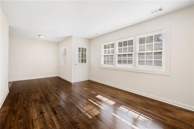 spare room featuring dark hardwood / wood-style floors