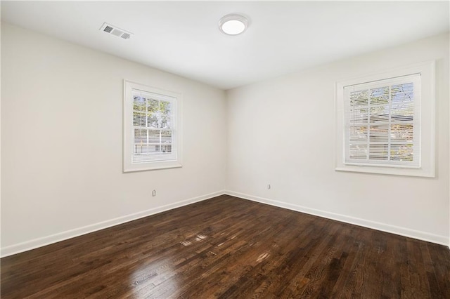 spare room with dark hardwood / wood-style flooring