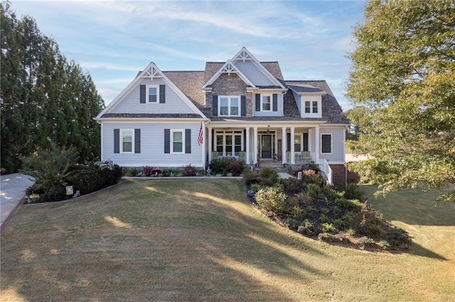 craftsman-style home with covered porch and a front lawn