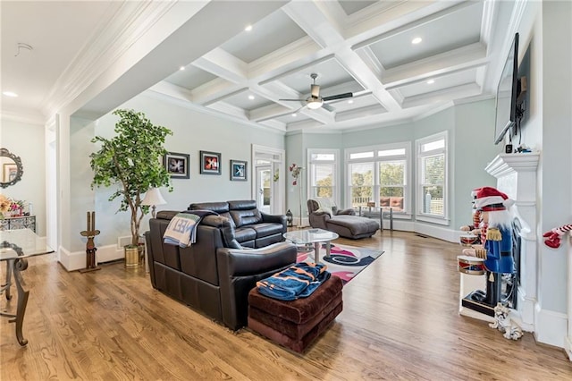 living room with beamed ceiling, ornamental molding, light hardwood / wood-style floors, and ceiling fan