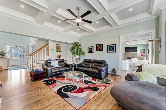 living room with beamed ceiling, ornamental molding, light hardwood / wood-style floors, and ceiling fan