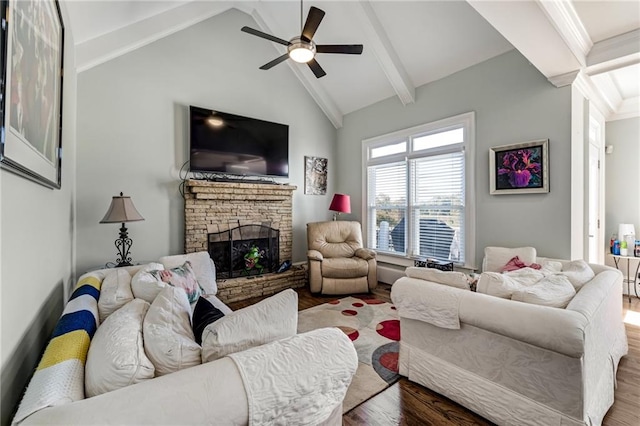 living room with a stone fireplace, vaulted ceiling with beams, wood-type flooring, and ceiling fan