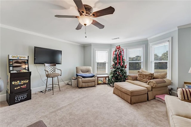 carpeted living room with crown molding and ceiling fan