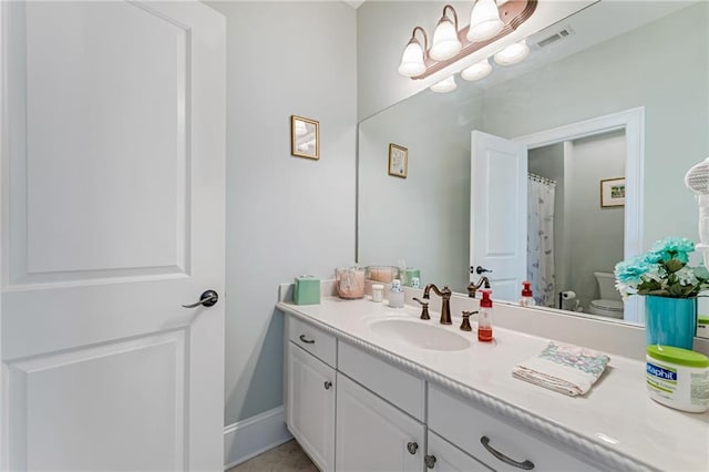 bathroom with vanity and toilet