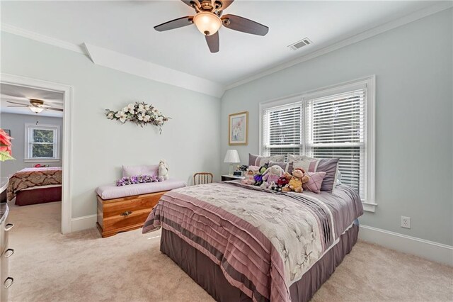 bedroom featuring crown molding, light carpet, and ceiling fan