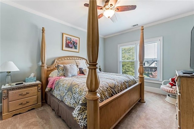 carpeted bedroom with ceiling fan and crown molding