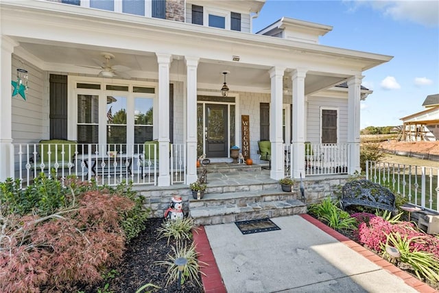 view of exterior entry with covered porch and ceiling fan