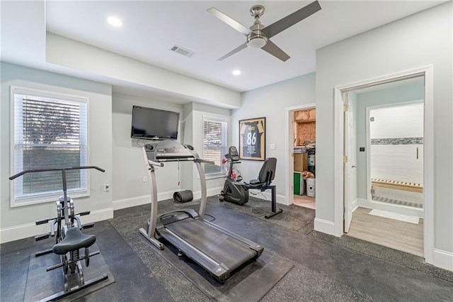 exercise area with dark wood-type flooring and ceiling fan