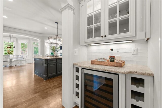 15910 Meadow King Way, Milton, GA 30004 - indoor dry bar with beverage cooler, wood finished floors, tasteful backsplash, recessed lighting, and ornamental molding
