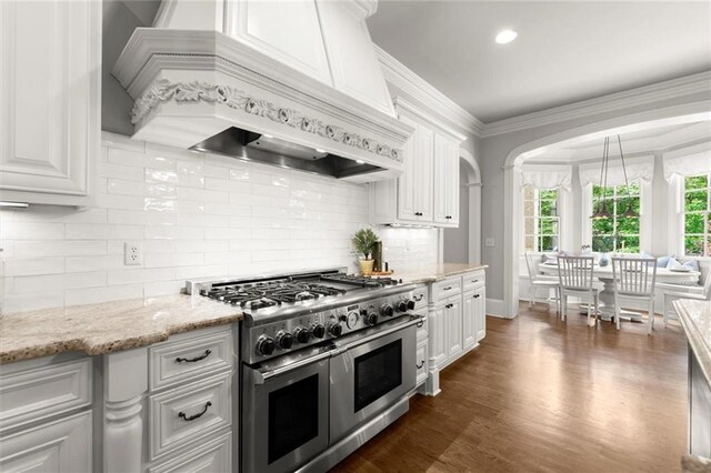 15910 Meadow King Way, Milton, GA 30004 - kitchen featuring double oven range, custom range hood, white cabinets, tasteful backsplash, and dark wood-style flooring
