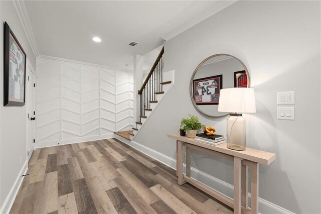 15910 Meadow King Way, Milton, GA 30004 - hallway featuring ornamental molding, wood finished floors, stairs, and recessed lighting