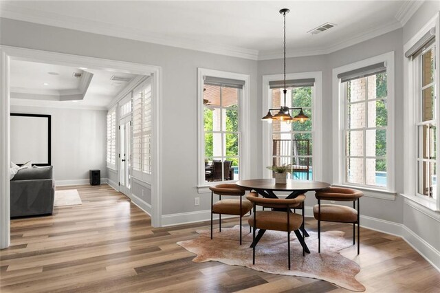 15910 Meadow King Way, Milton, GA 30004 - dining space with plenty of natural light, light wood finished floors, crown molding, and a chandelier