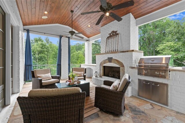 15910 Meadow King Way, Milton, GA 30004 - view of patio with ceiling fan, an outdoor kitchen, an outdoor living space with a fireplace, and view of scattered trees