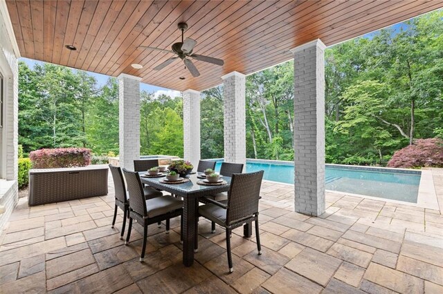 15910 Meadow King Way, Milton, GA 30004 - view of patio featuring a ceiling fan, an outdoor pool, outdoor dining space, and view of wooded area
