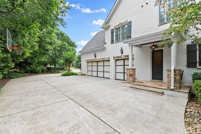 15910 Meadow King Way, Milton, GA 30004 - view of home's exterior with a garage, brick siding, and concrete driveway