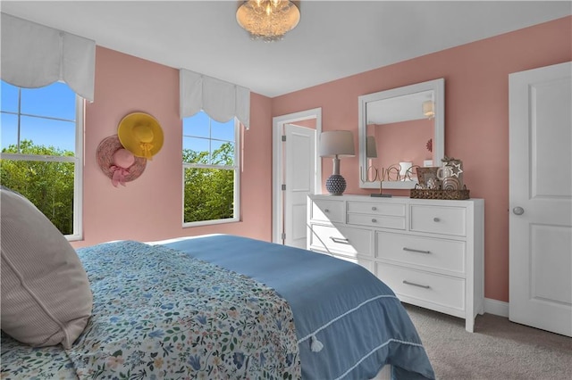 bedroom with carpet flooring, multiple windows, and baseboards