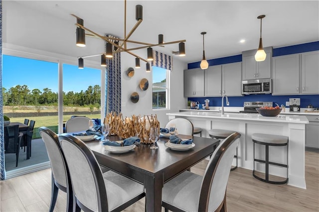 dining room with recessed lighting and light wood-style flooring