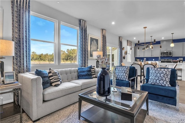 living area featuring recessed lighting and light wood-style flooring