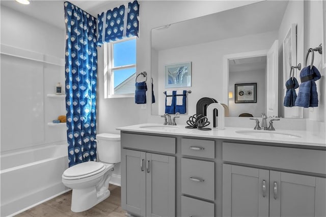 bathroom with toilet, double vanity, shower / bath combination with curtain, and wood finished floors