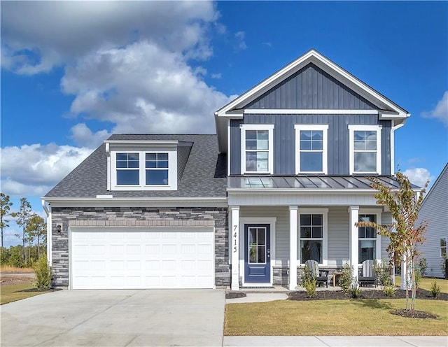 craftsman inspired home with covered porch, stone siding, driveway, a front lawn, and a standing seam roof