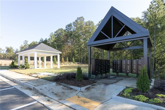 view of community featuring uncovered parking, a gazebo, and mail area