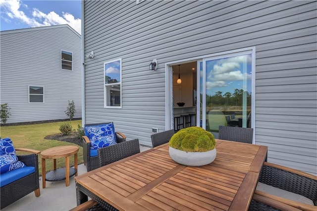 deck with outdoor dining area and a patio