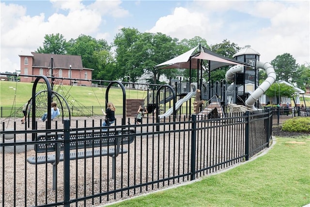 view of gate with a yard and fence