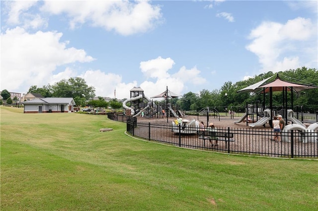 community playground with a yard and fence