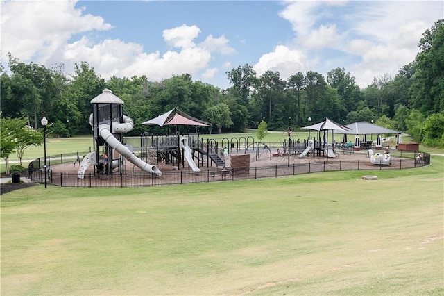 community playground with a yard and fence