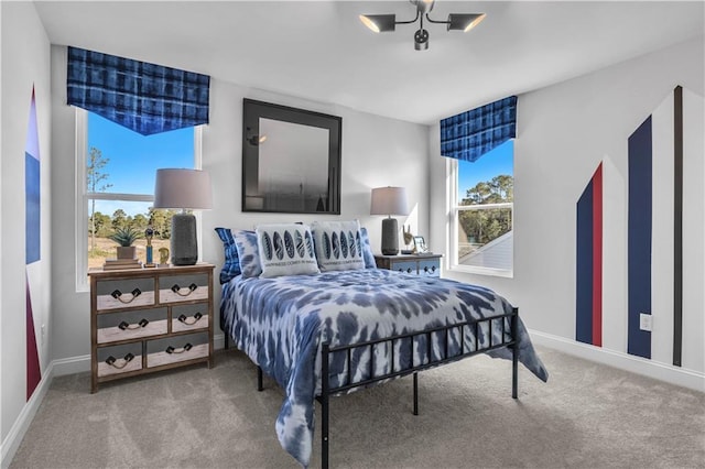 carpeted bedroom featuring baseboards