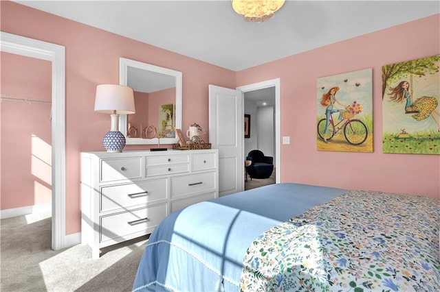 carpeted bedroom featuring baseboards