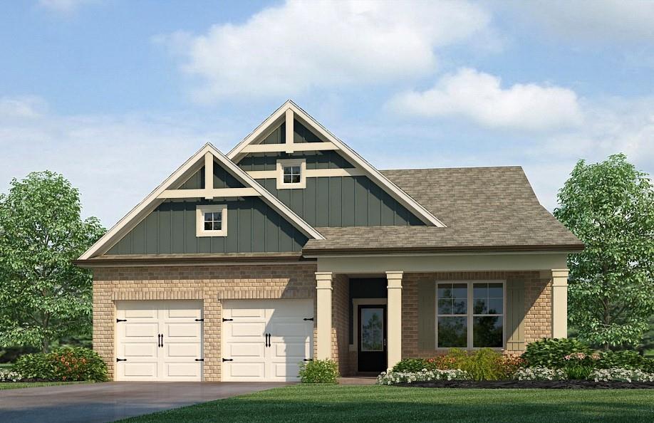 craftsman inspired home with a garage and a front yard