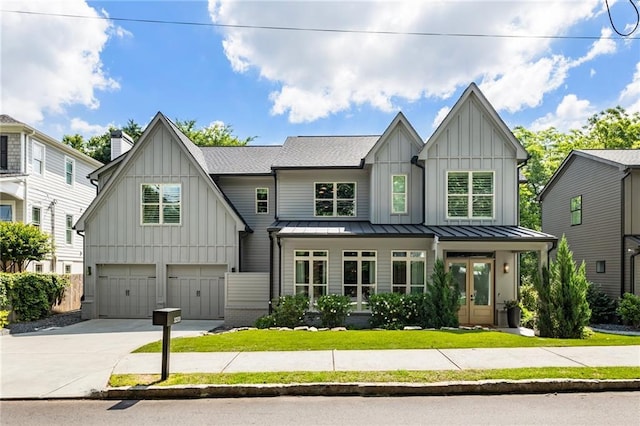 3233 Osborne Rd NE, Brookhaven, GA 30319 - modern farmhouse featuring board and batten siding, a garage, driveway, a standing seam roof, and a front lawn