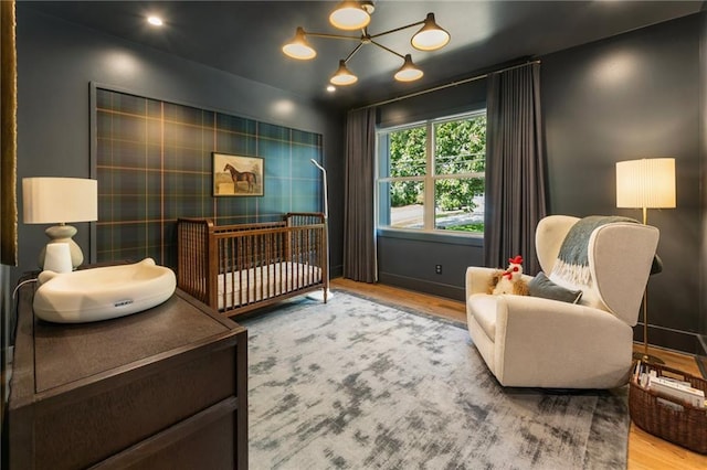 3233 Osborne Rd NE, Brookhaven, GA 30319 - bedroom with wood finished floors, a nursery area, and baseboards