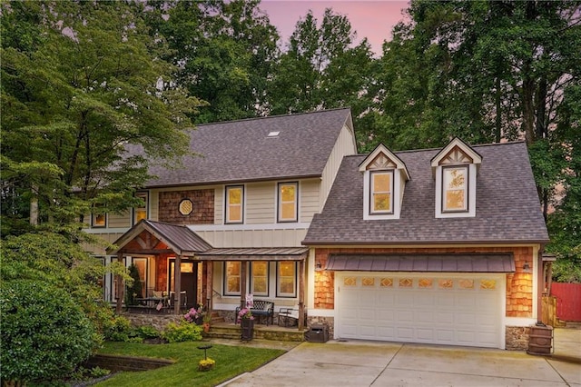 1438 Salem Dr, Alpharetta, GA 30009 - view of front of home with covered porch, concrete driveway, a shingled roof, stone siding, and a standing seam roof