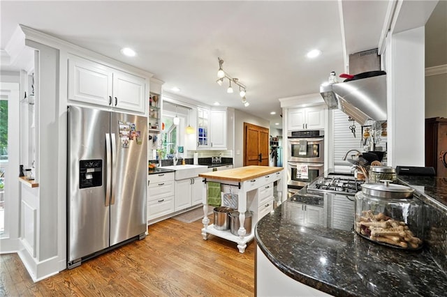 1438 Salem Dr, Alpharetta, GA 30009 - kitchen featuring stainless steel appliances, wood counters, light wood-style floors, white cabinets, and recessed lighting